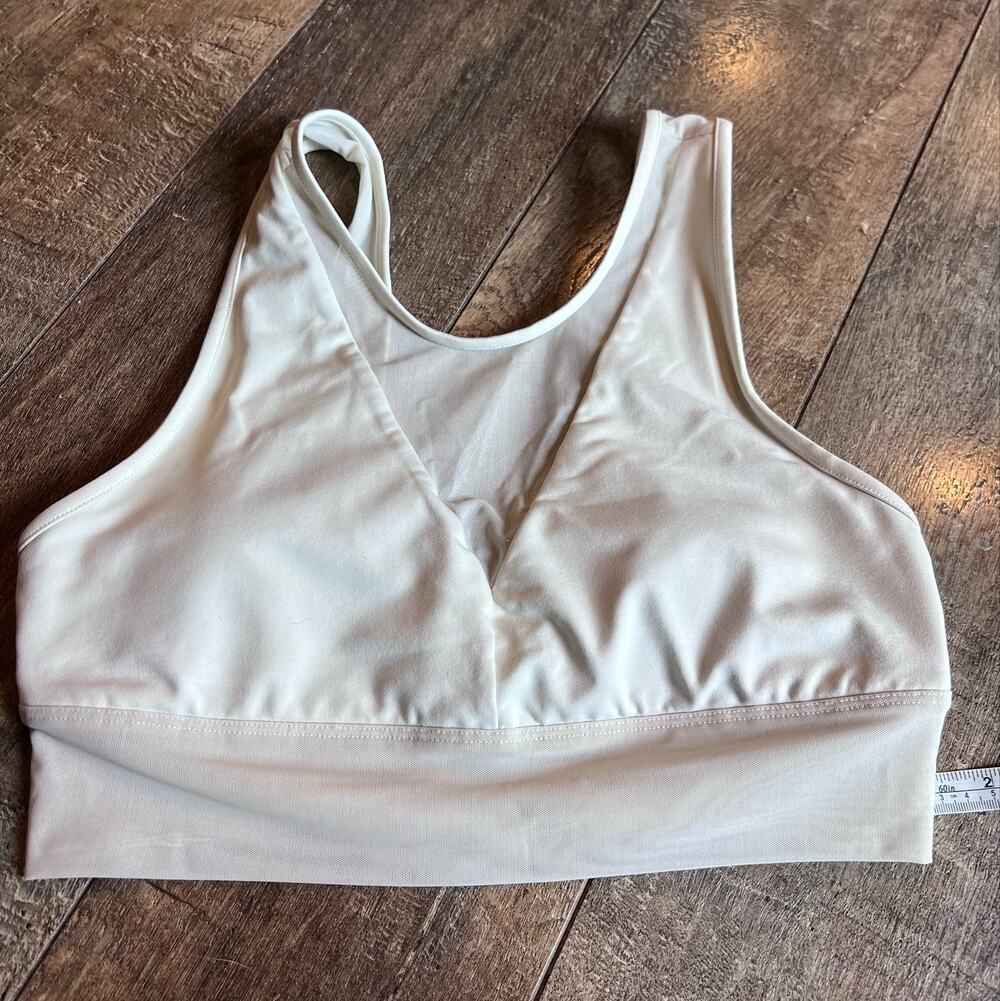 Alo Yoga Jubilee Yoga Sports Bra features a sheer mesh V-neck